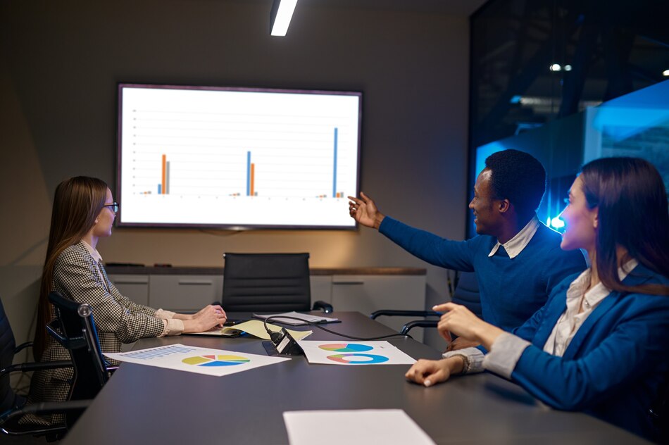 Team using projectors to present data in a modern meeting room